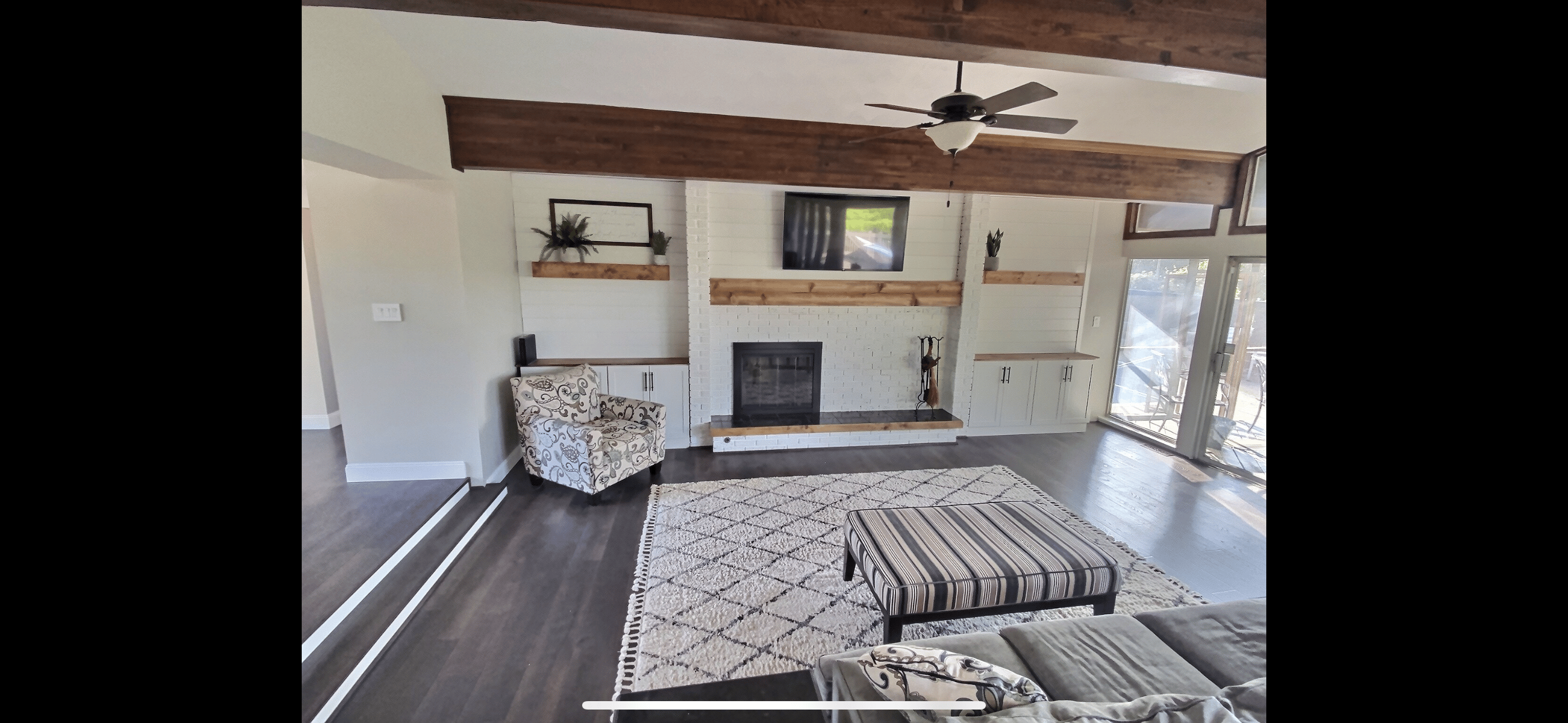 Transformed family room with new flooring, painted walls, and updated decor