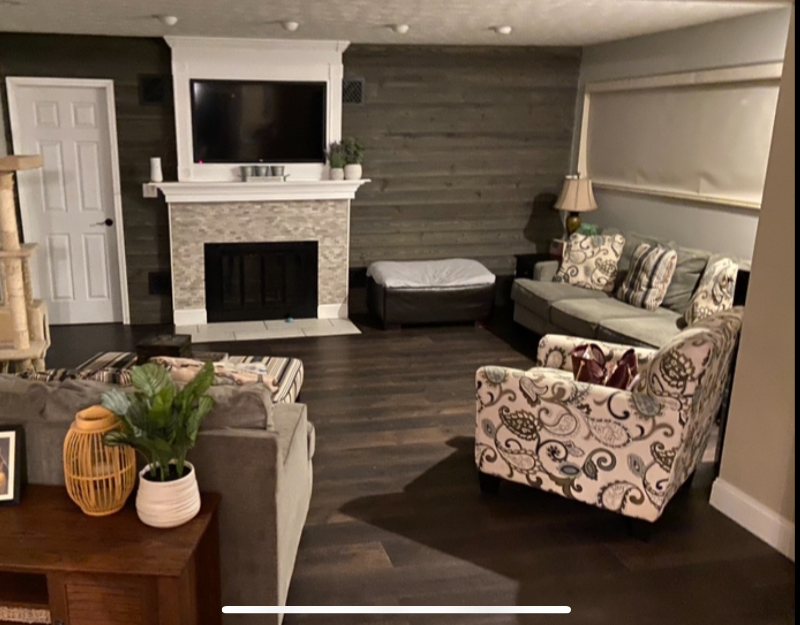 Beautifully renovated living room with modern furniture and updated fireplace